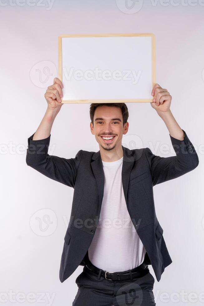 Portrait of happy businessman showing blank signboard on isolated white background photo