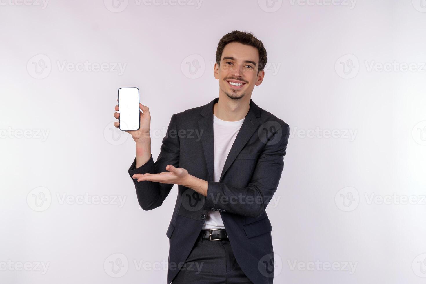 Portrait of young businessman holding smartphone cellphone blank screen with mockup copy space isolated white background photo