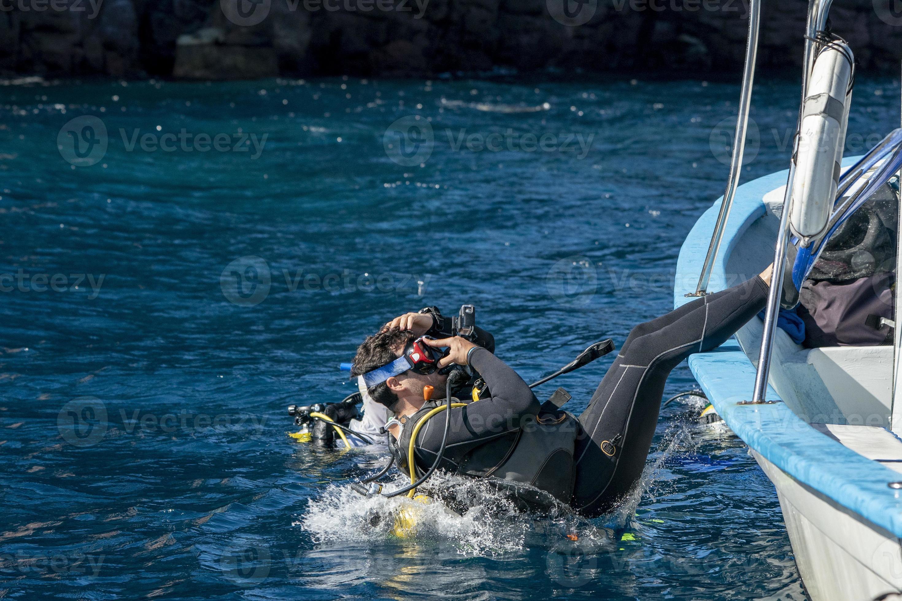 scuba diver entering water from boat 20383771 Stock Photo at Vecteezy