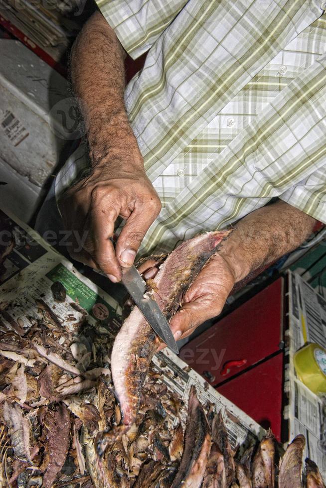 Hand of old man in the fish market photo