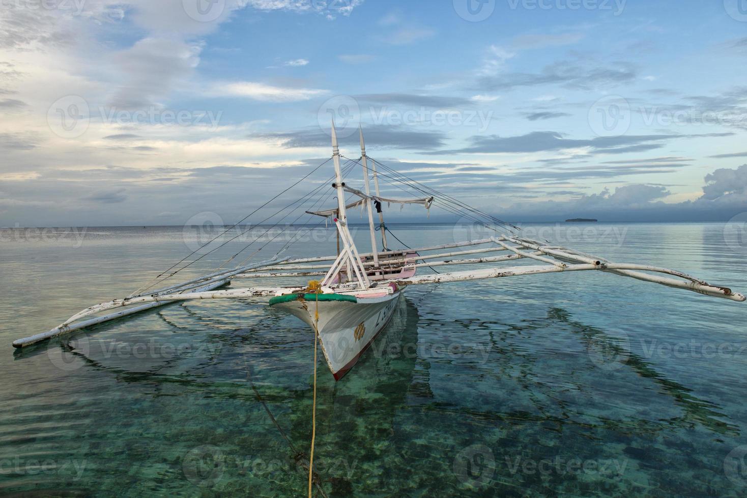 a boat in a tropical paradise beach sunrise photo