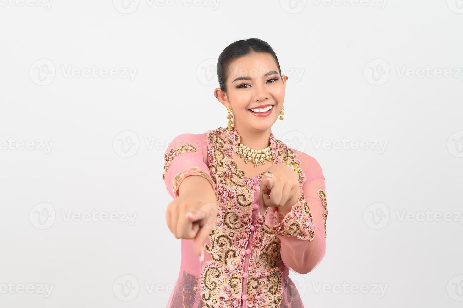 Young beautiful woman dress up in local culture in southern region point finger posture photo