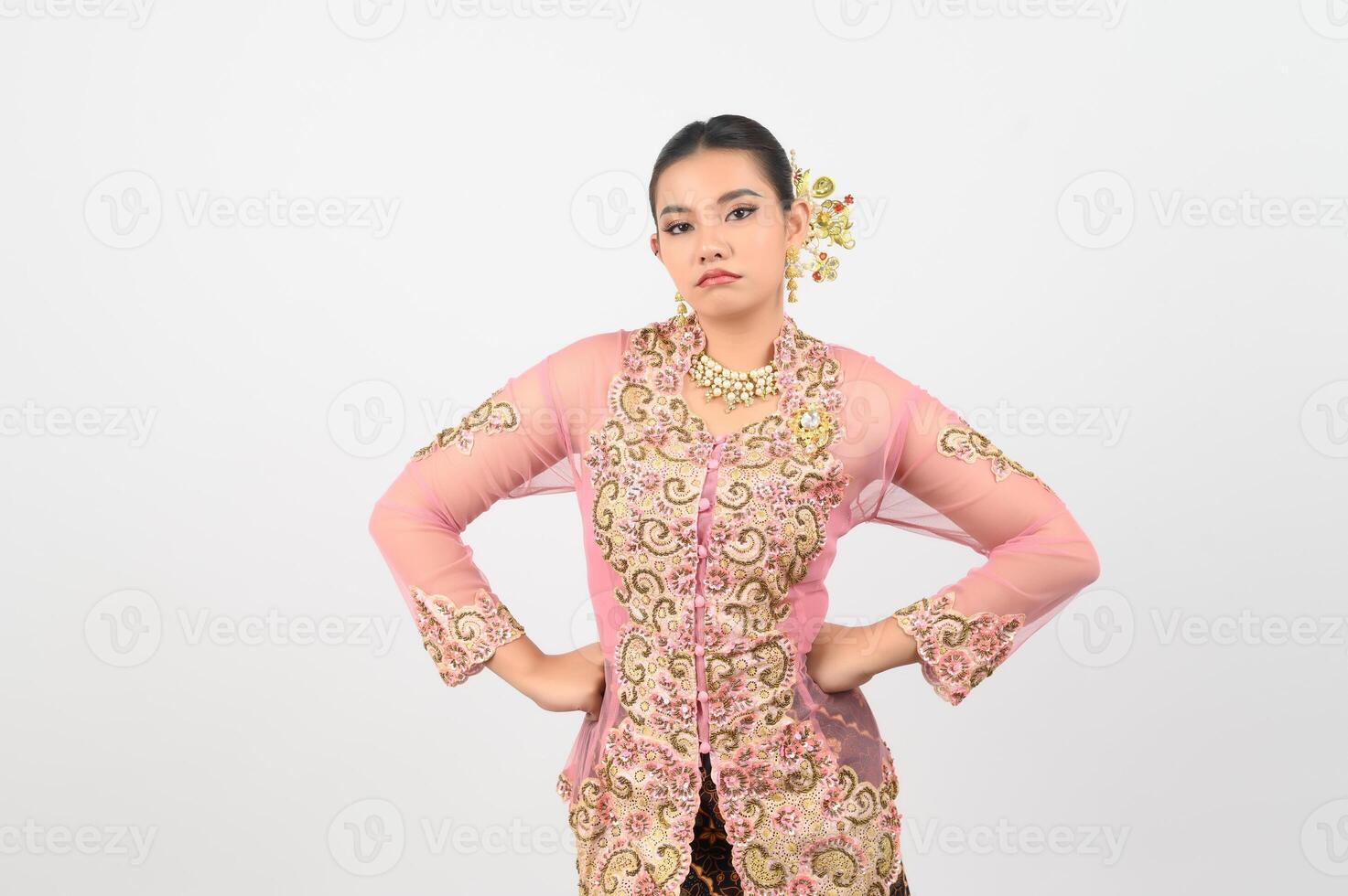 Young beautiful woman dress up in local culture in southern region with upset posture photo