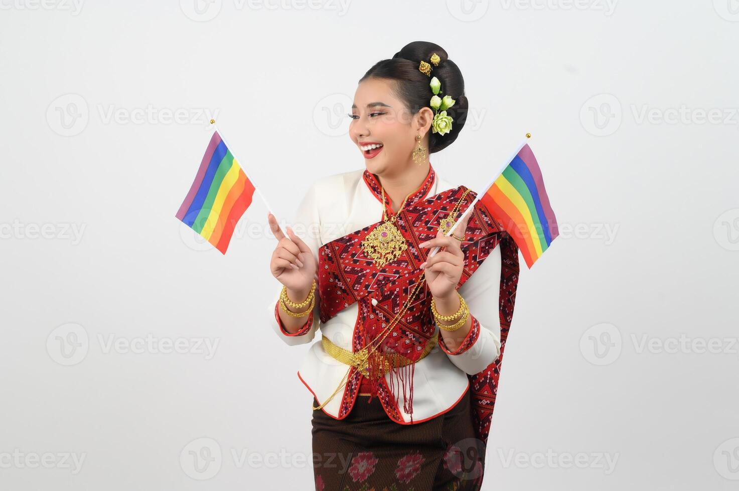 Portrait of Young woman in Thai Northeastern Traditional Clothing holding rainbow flag photo