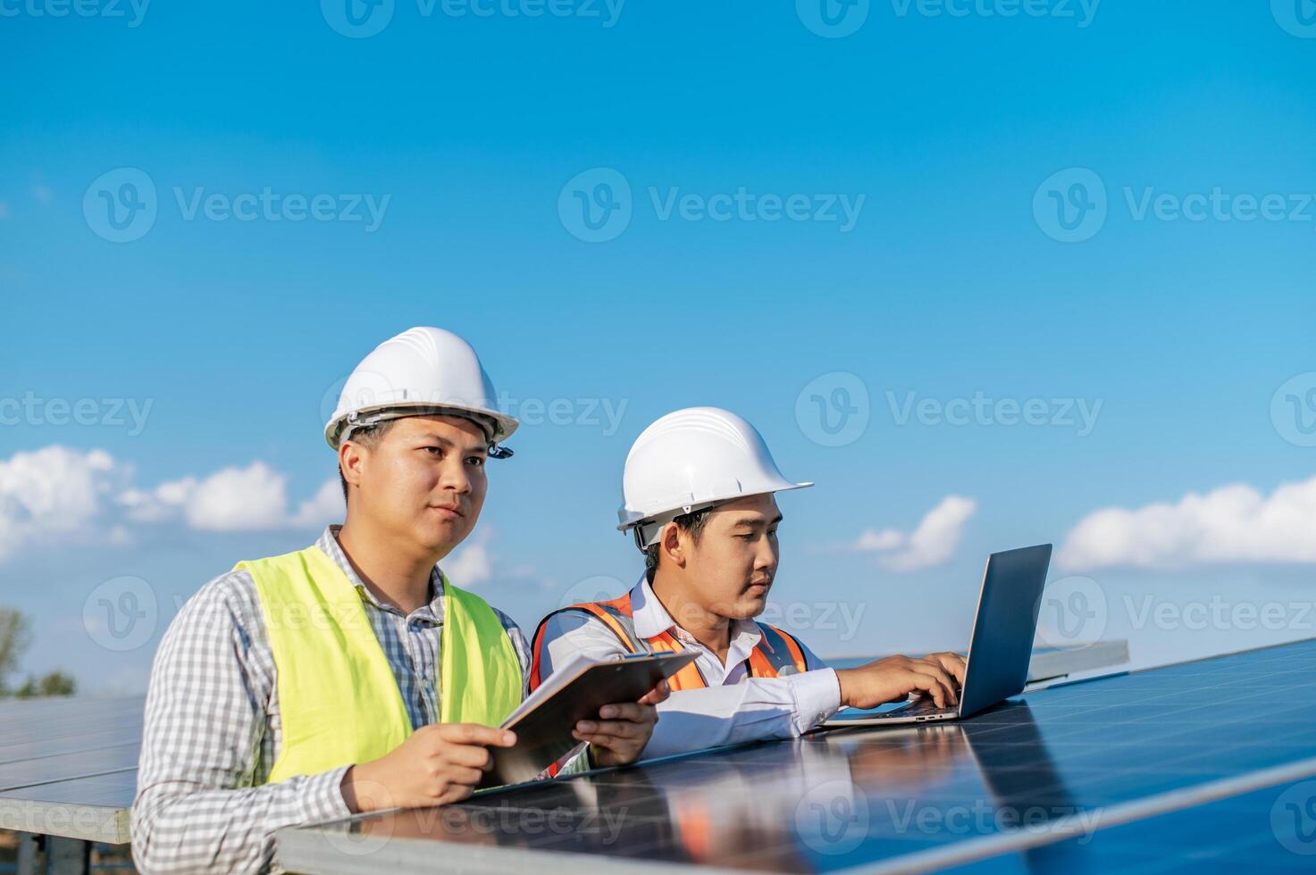 Two engineers are discussing during working at solar farm photo