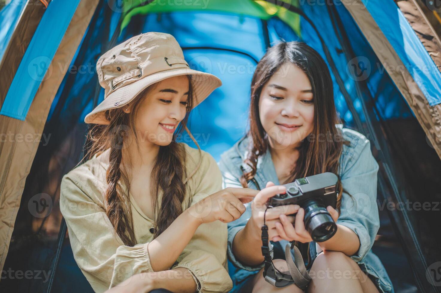 Young woman use camera taking photo and show her friends
