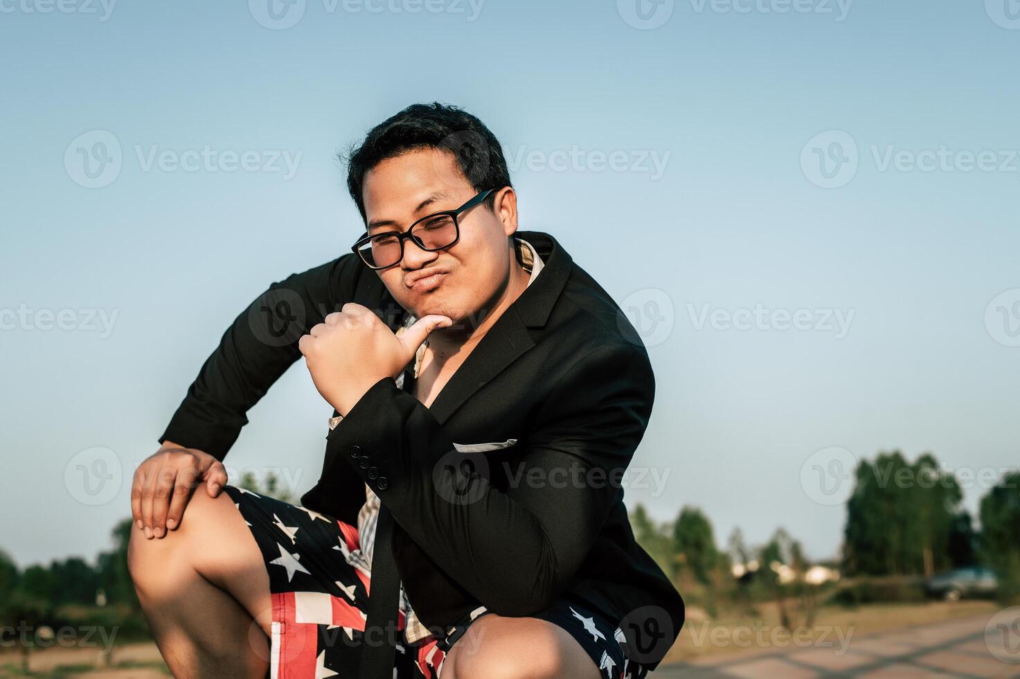 Young funny businessman man in crazy and funny manner posture photo