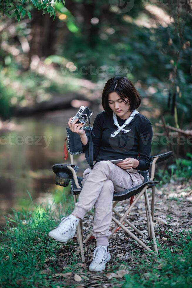 Young pretty woman use camera taking photo in nature park