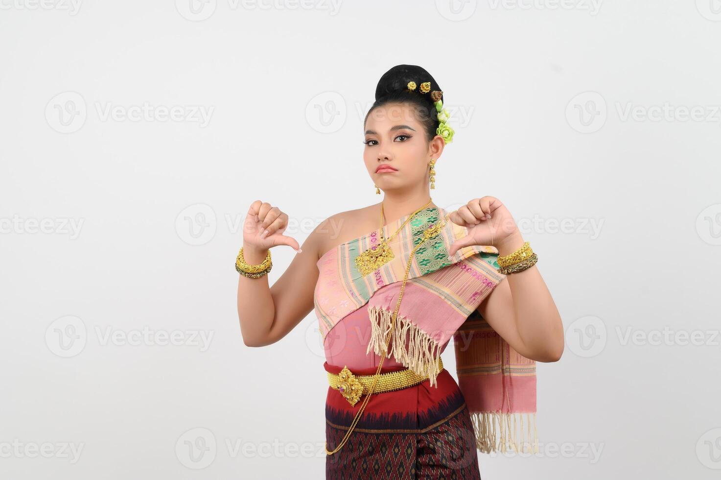 Young beautiful woman in costume of the northeastern region with thumb down posture photo