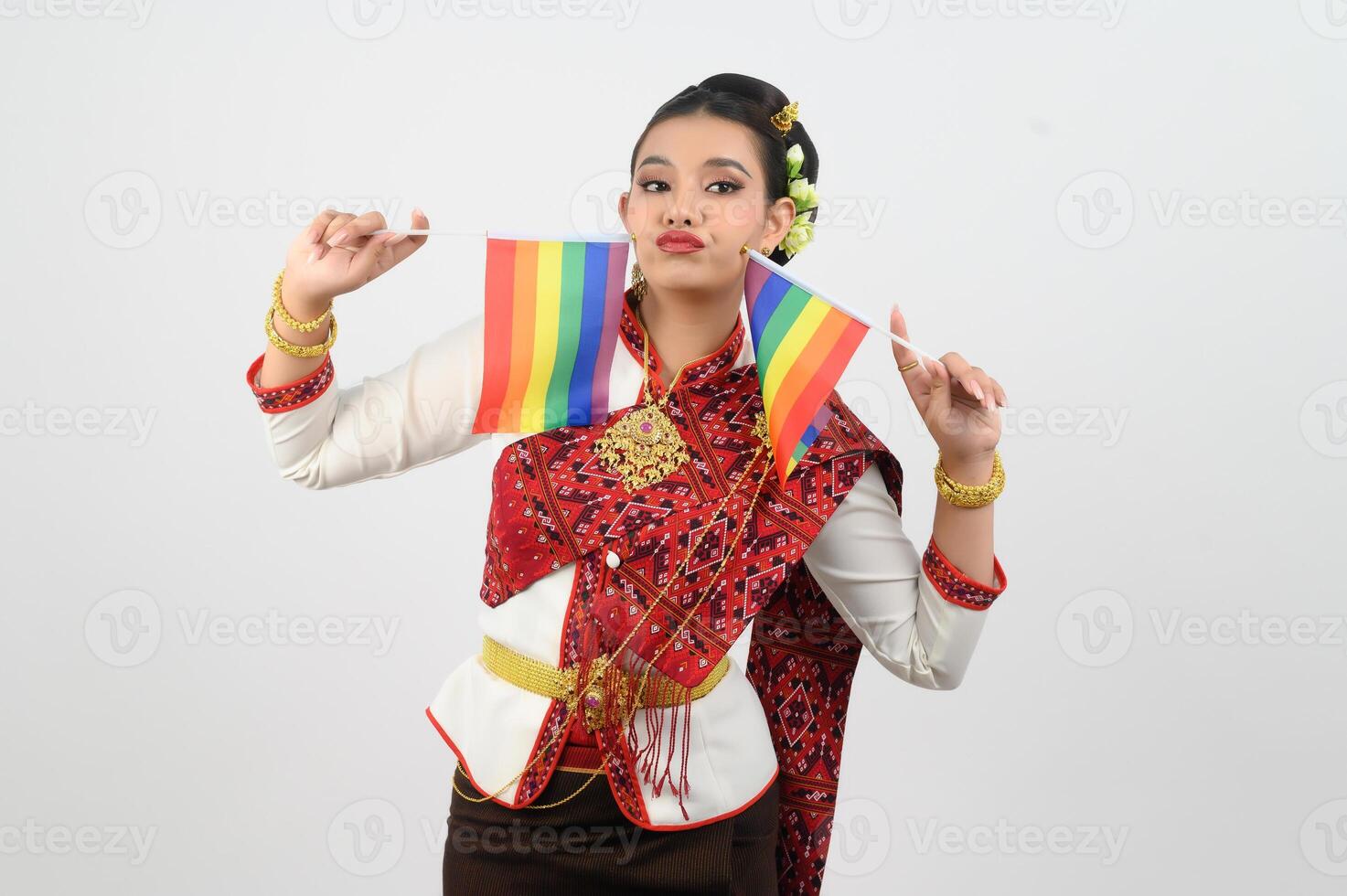 Portrait of Young woman in Thai Northeastern Traditional Clothing holding rainbow flag photo