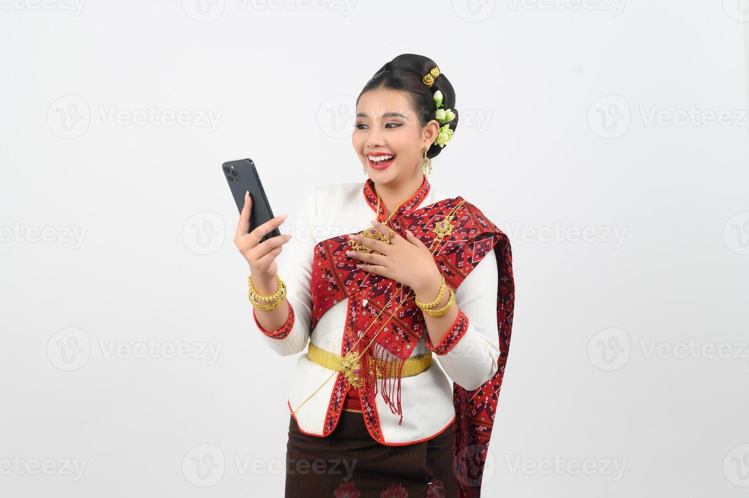 Portrait of Beautiful Thai Woman in Traditional Clothing Posing with smartphone photo
