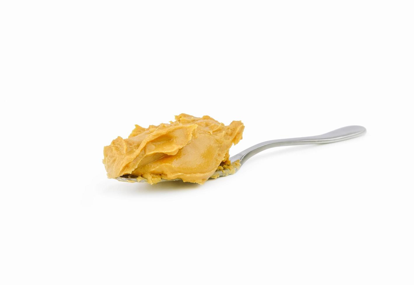 creamy peanut butter on spoon photo
