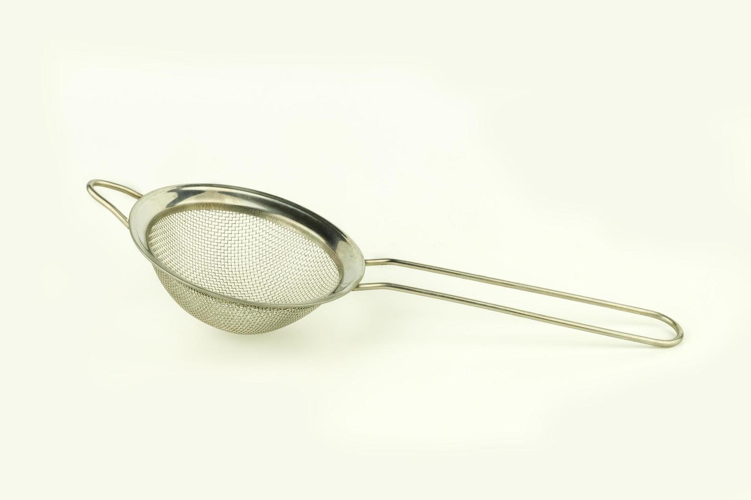 shiny colander on white background photo