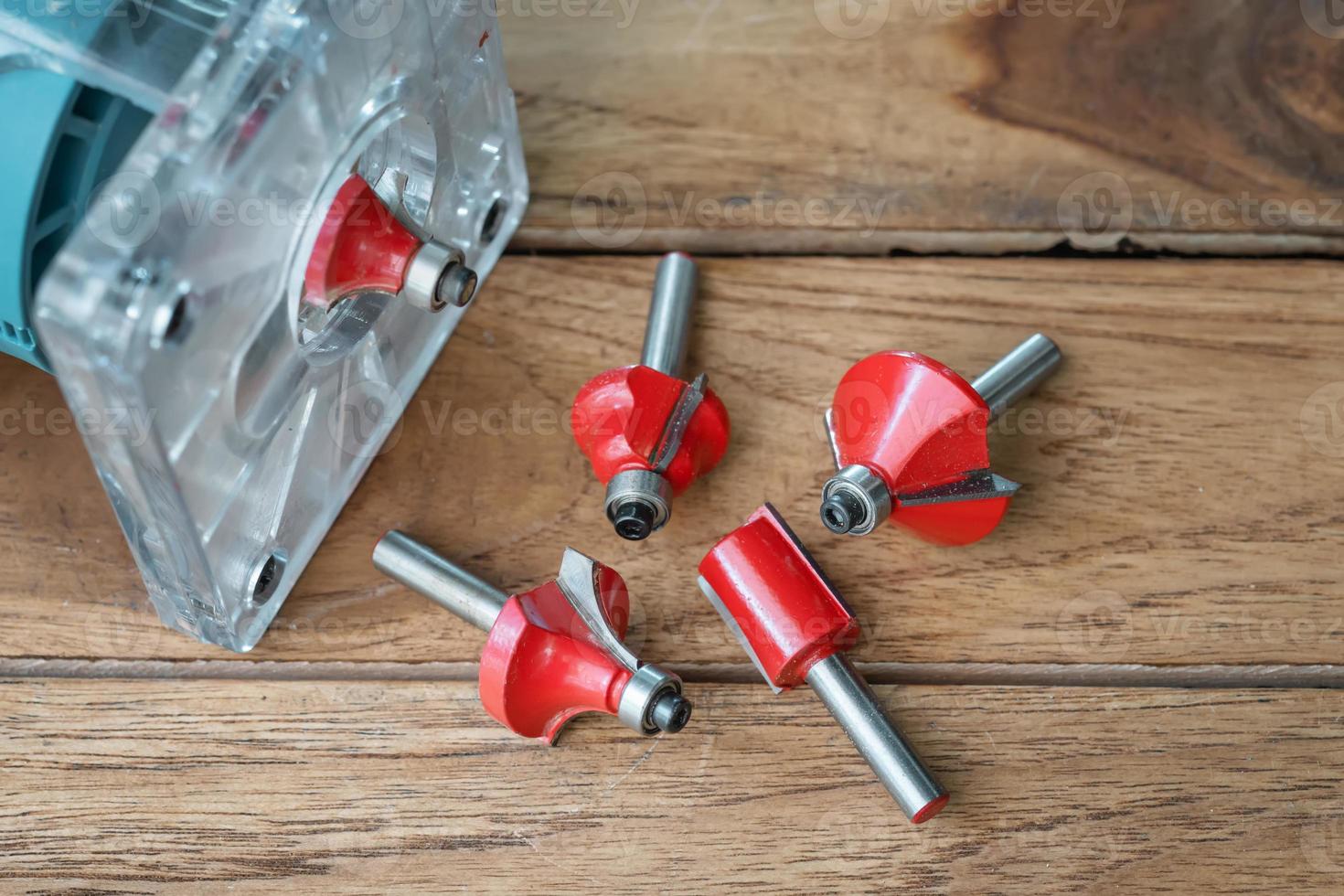 Router Bit and Trimmer router for Wood on wooden background, DIY maker and woodworking power tools concept. selective focus photo