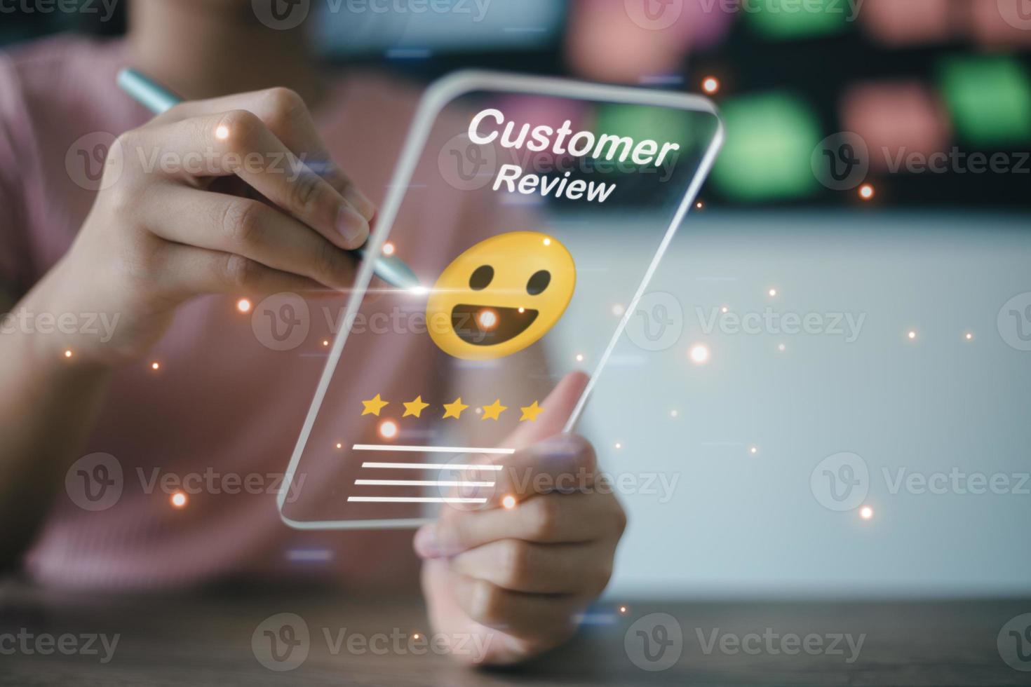 Businesswoman pressing face emoticon on virtual touch screen at smartphone .Customer service evaluation concept. photo