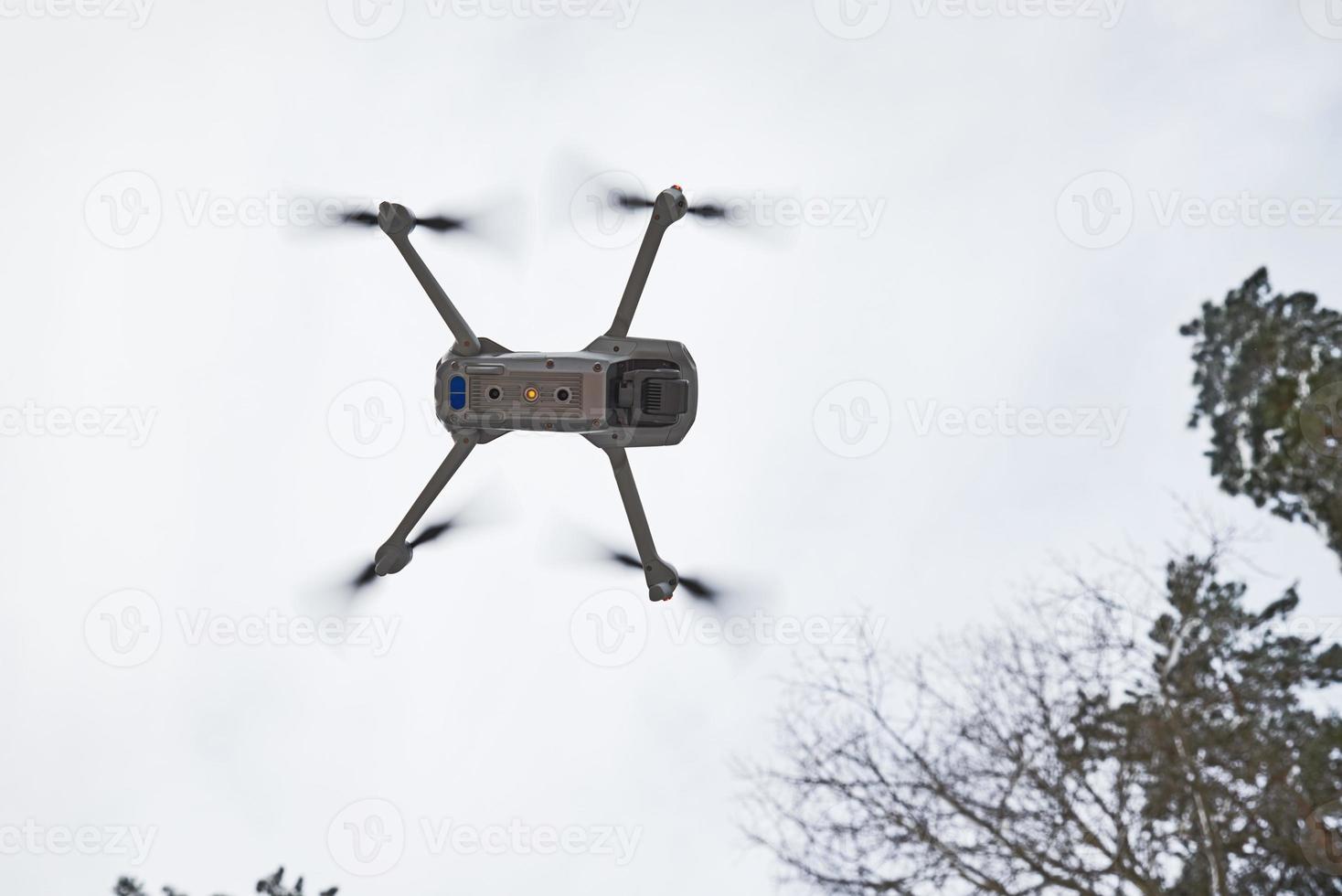 Drone quadcopter with camera flying in sky photo