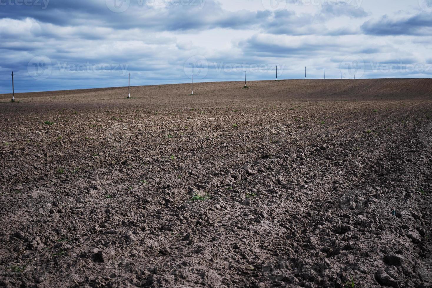 Plowed field in a spring day. Plowed soil for planting crops photo