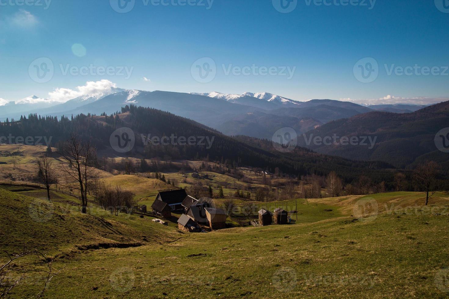 Farmhouse in valley between mountains landscape photo