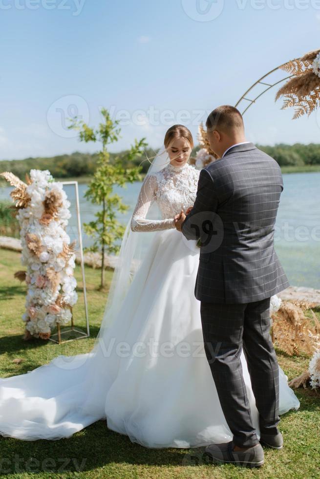 wedding ceremony of the newlyweds on the pier photo