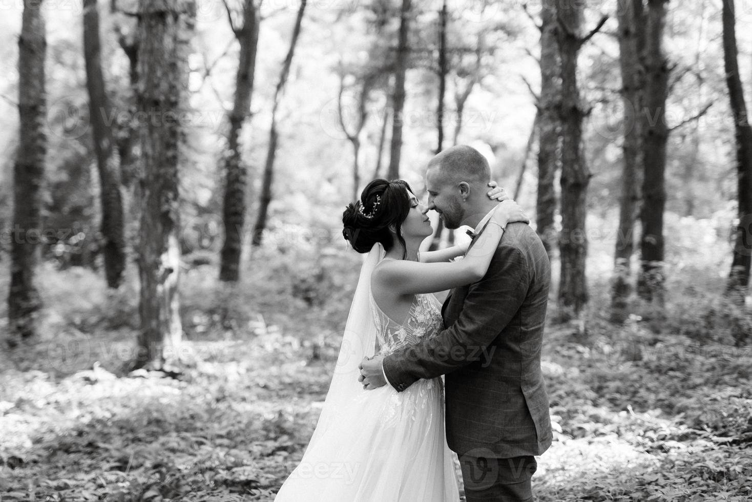 wedding walk of the bride and groom in the deciduous forest in summer photo