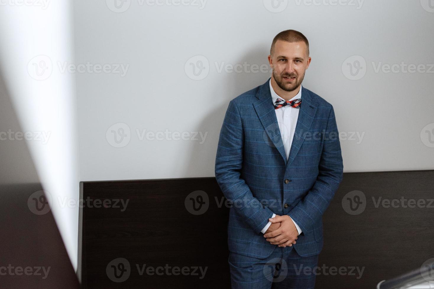 portrait of smiling groom with beard photo