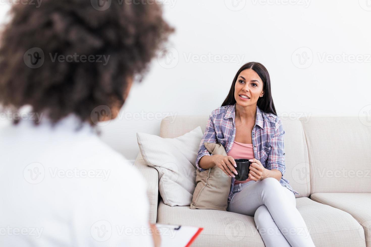 Psychologist listening to her patient and writing notes, mental health and counseling. Psychologist consulting and psychological therapy session concept photo
