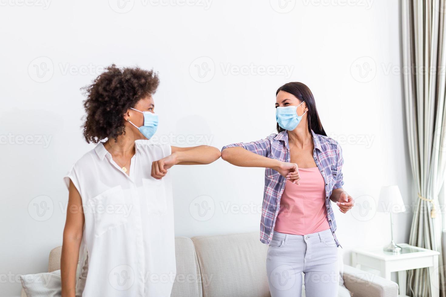 Elbow bump. New novel greeting to avoid the spread of coronavirus. Two women friends meet with bare hands. Instead of greeting with a hug or handshake, they bump elbows instead. photo