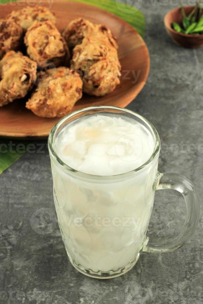 Es Kelapa Muda or Young Coconut Drink with Bala-Bala Vegetable Fritter. photo