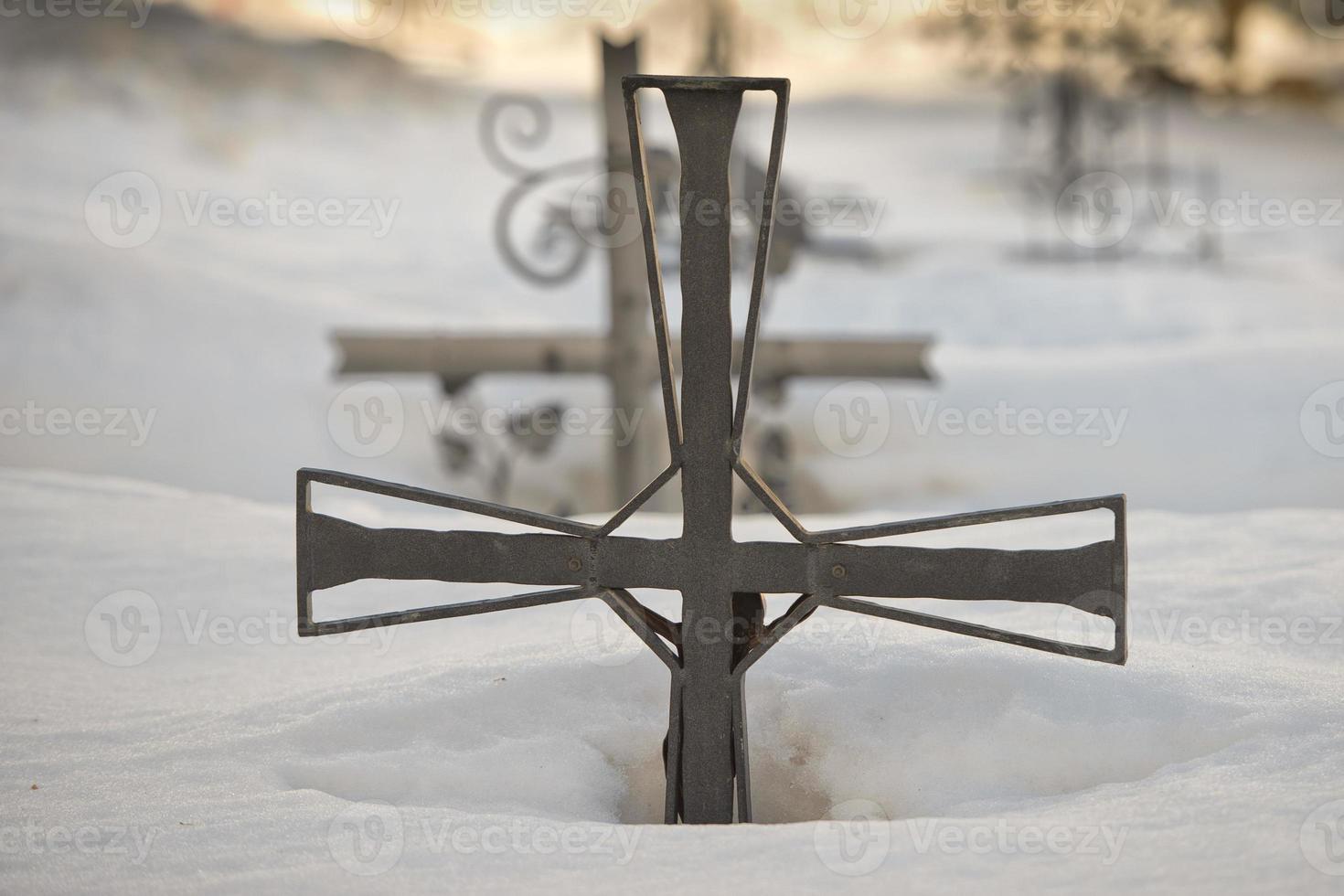 cemetery cross covered by snow photo