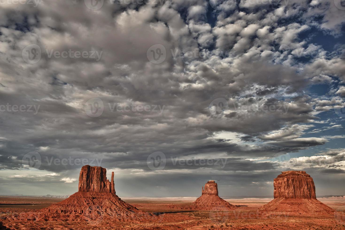 Monument Valley view at sunset with wonderfull cloudy sky and lights on mittens photo