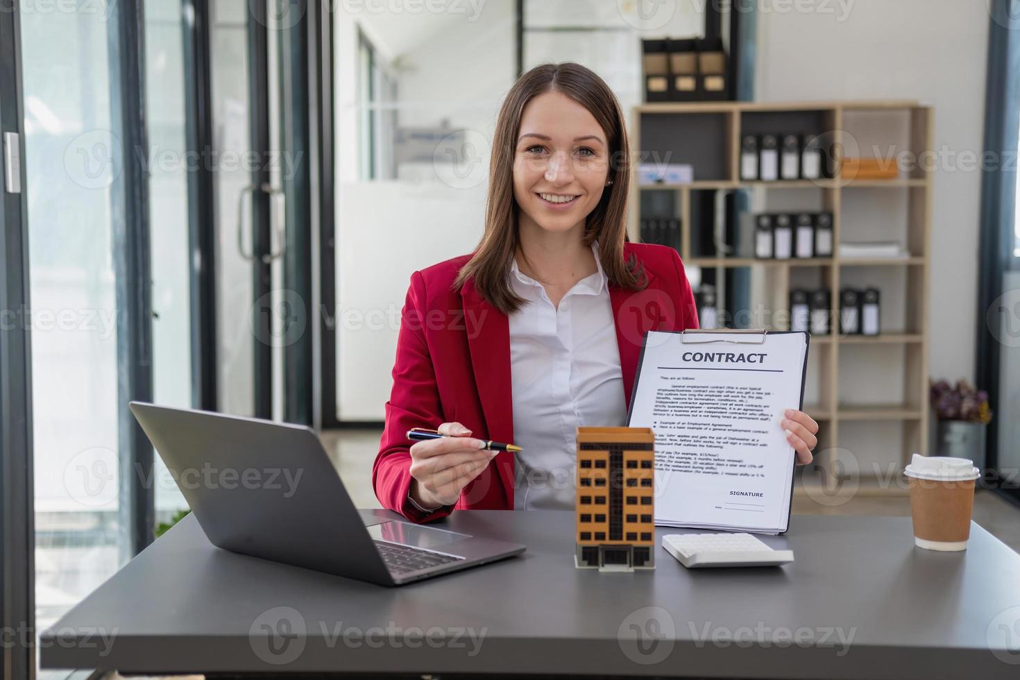 Accountant, businessman, real estate agent, Businessman handing model house to customers along with house interest calculation documents for customers to sign. photo