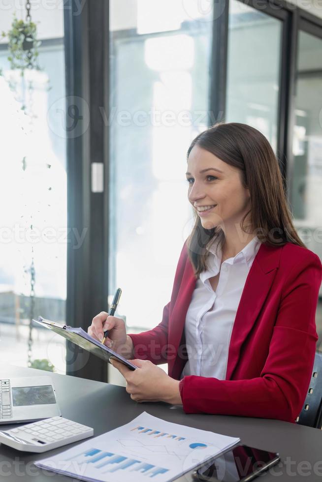 Marketing, Finance, Accounting, Planning, Team female accountant using laptop calculator and documents, charts, graphs in the analysis of the company is profit. photo