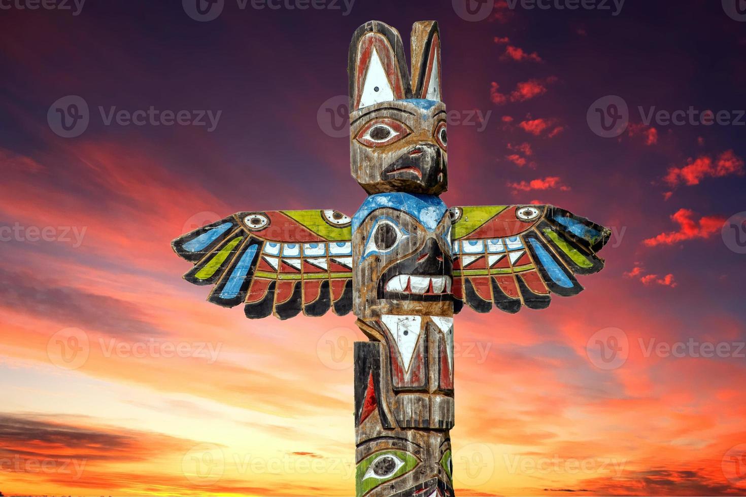 Totem wood pole in the gold cloudy background photo