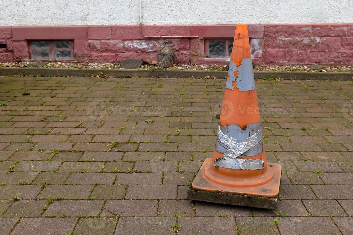 a road cone on a sidewalk photo