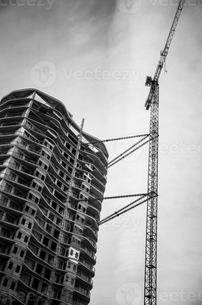 Black and white image of a modern multistory building construction. photo