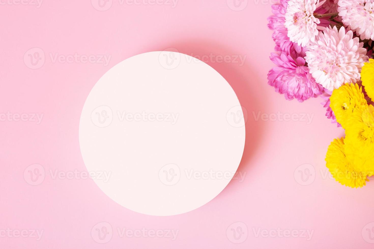 Podium or pedestal with chrysanthemum flowers top view. Mockup for your cosmetic products photo