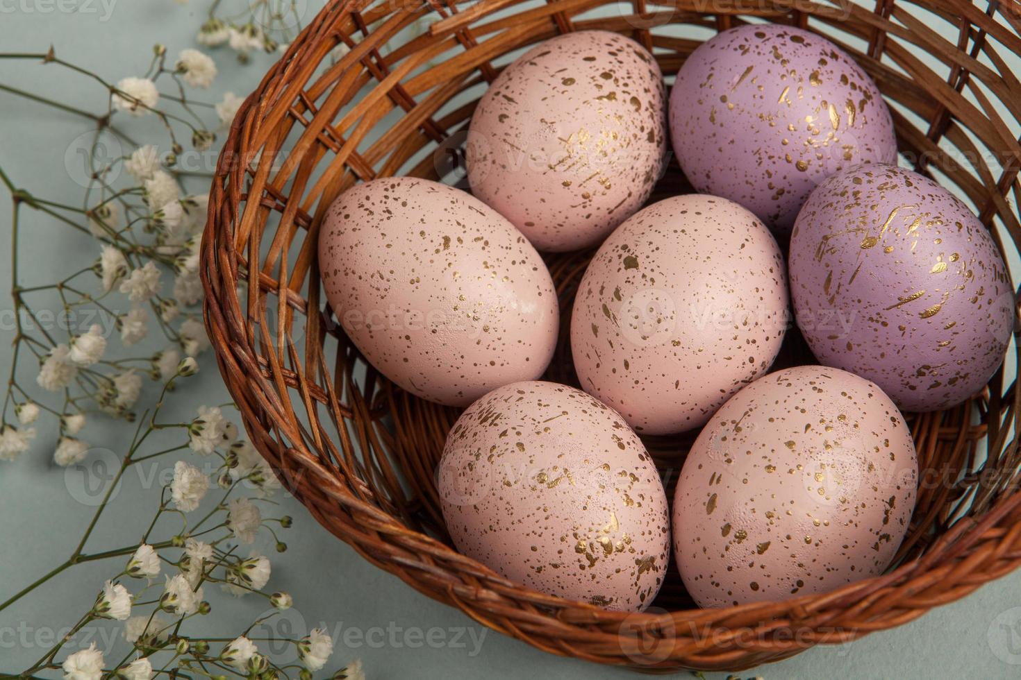 banner. Easter frame with eggs and feathers on a blue wooden background. Minimal concept. View from above. Card with copy space for text. photo