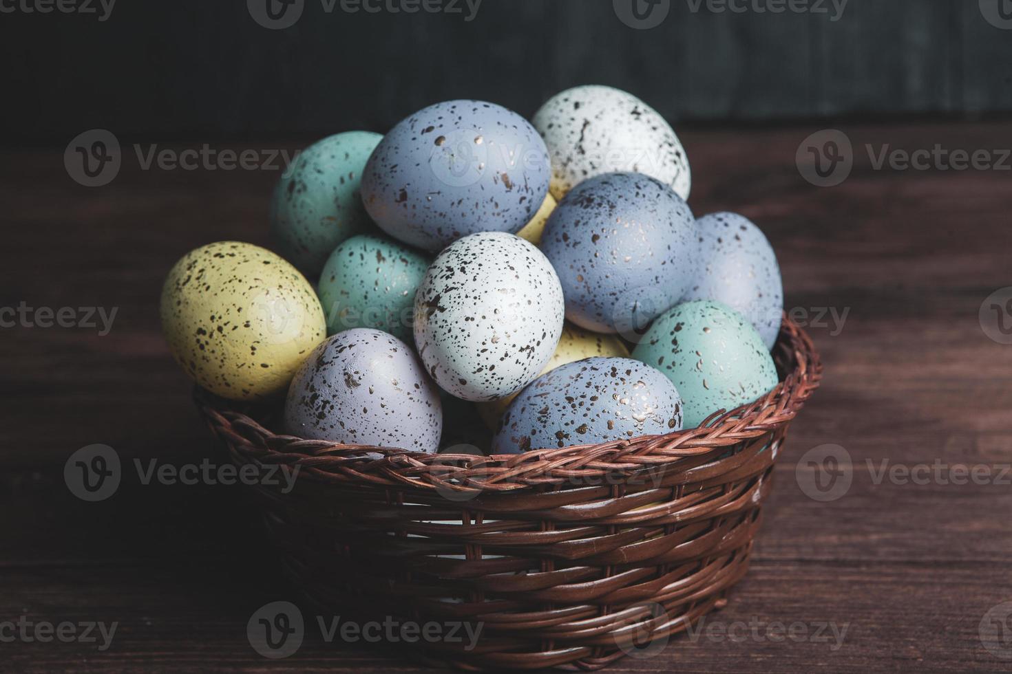 banner. Easter frame with eggs and feathers on a blue wooden background. Minimal concept. View from above. Card with copy space for text. photo