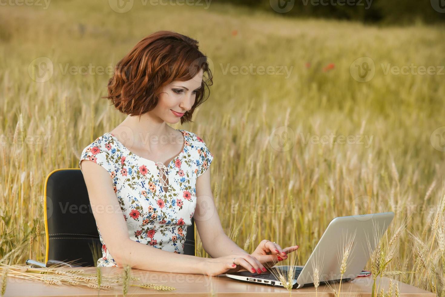 Beautiful woman or business woman talking on a cell phone outside. Outdoor portrait of a beautiful happy businesswoman talking on cell phone. photo