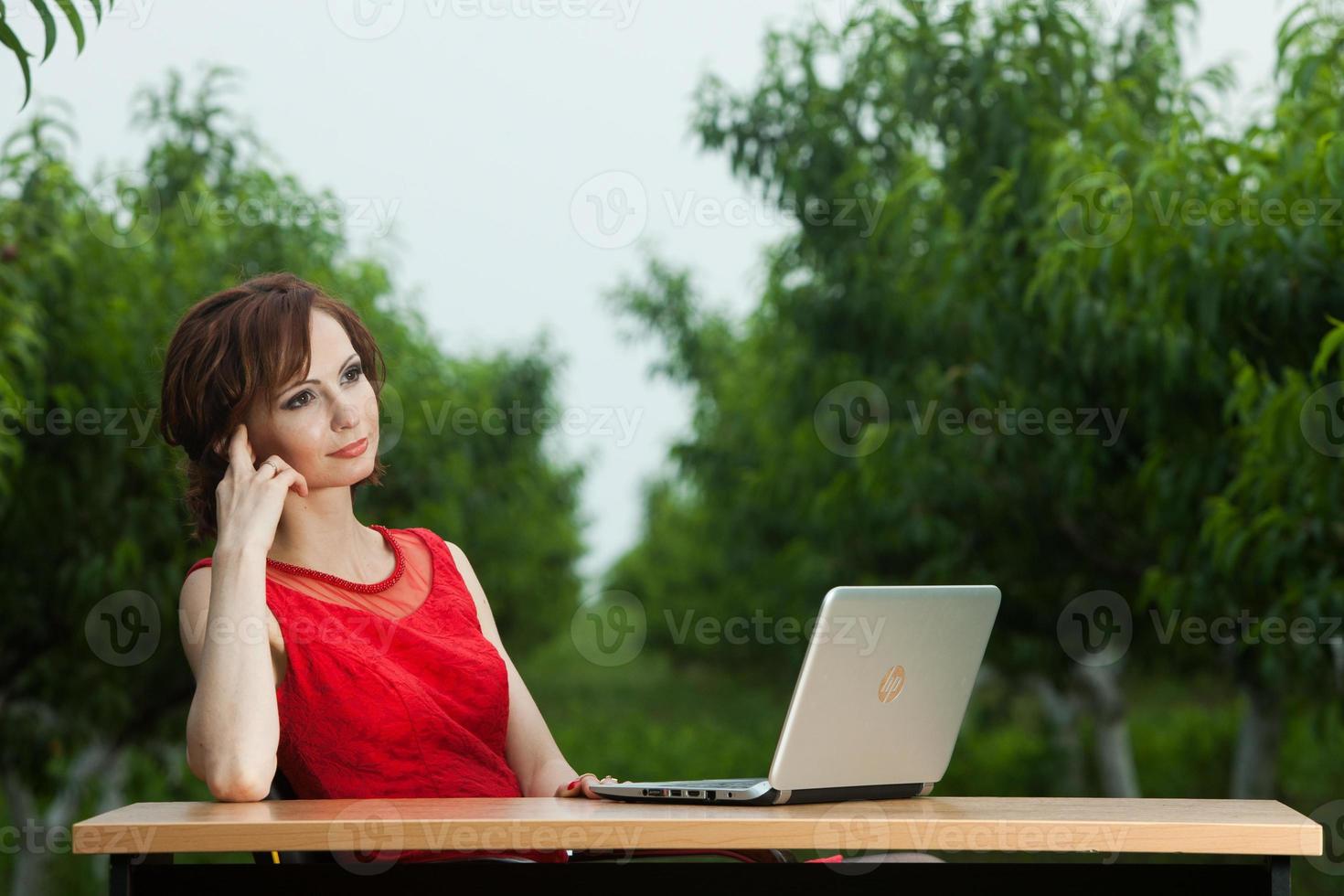Beautiful woman or business woman talking on a cell phone outside. Outdoor portrait of a beautiful happy businesswoman talking on cell phone. photo