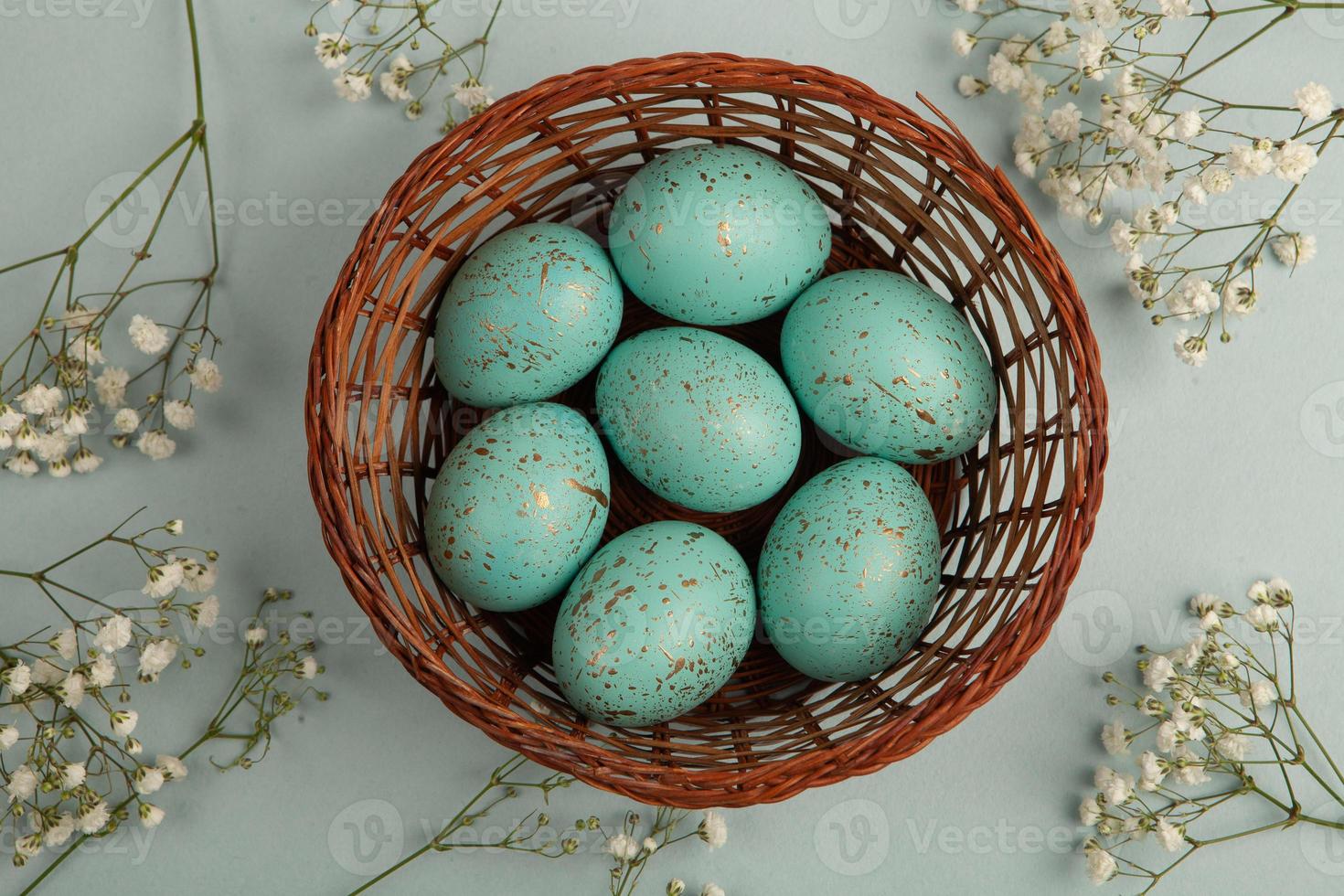 banner. Easter frame with eggs and feathers on a blue wooden background. Minimal concept. View from above. Card with copy space for text. photo