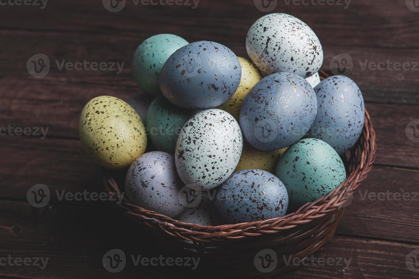 banner. Easter frame with eggs and feathers on a blue wooden background. Minimal concept. View from above. Card with copy space for text. photo