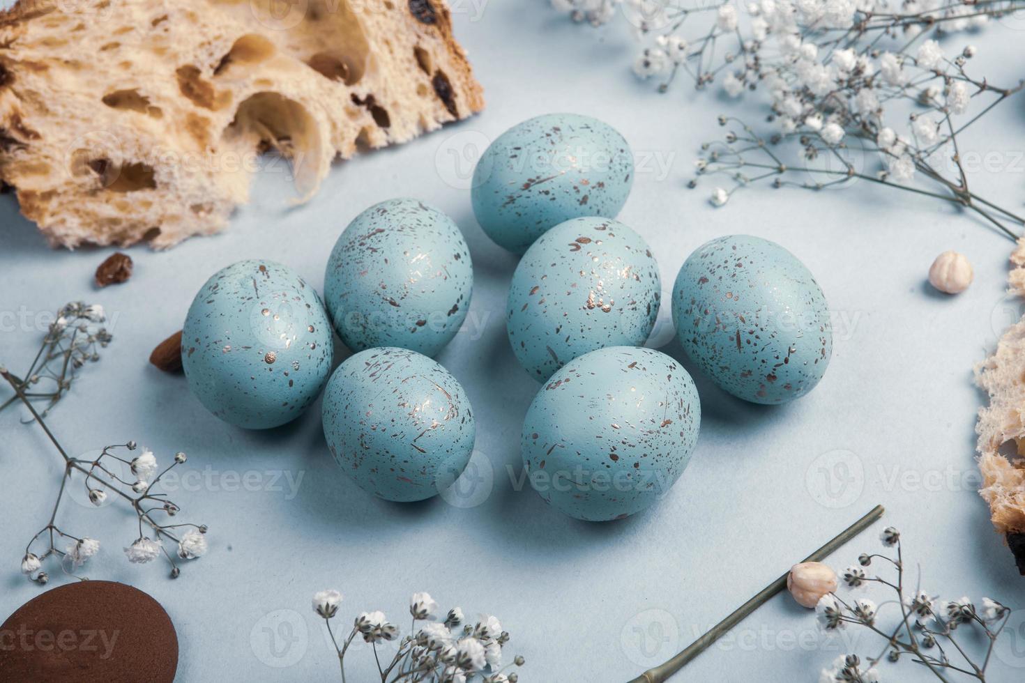 banner. Easter frame with eggs and feathers on a blue wooden background. Minimal concept. View from above. Card with copy space for text. photo