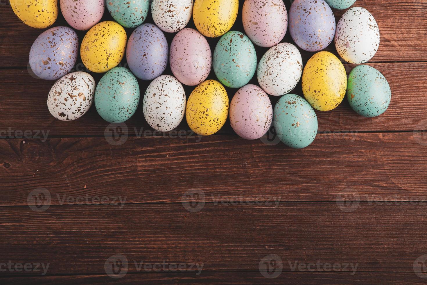 banner. Easter frame with eggs and feathers on a blue wooden background. Minimal concept. View from above. Card with copy space for text. photo