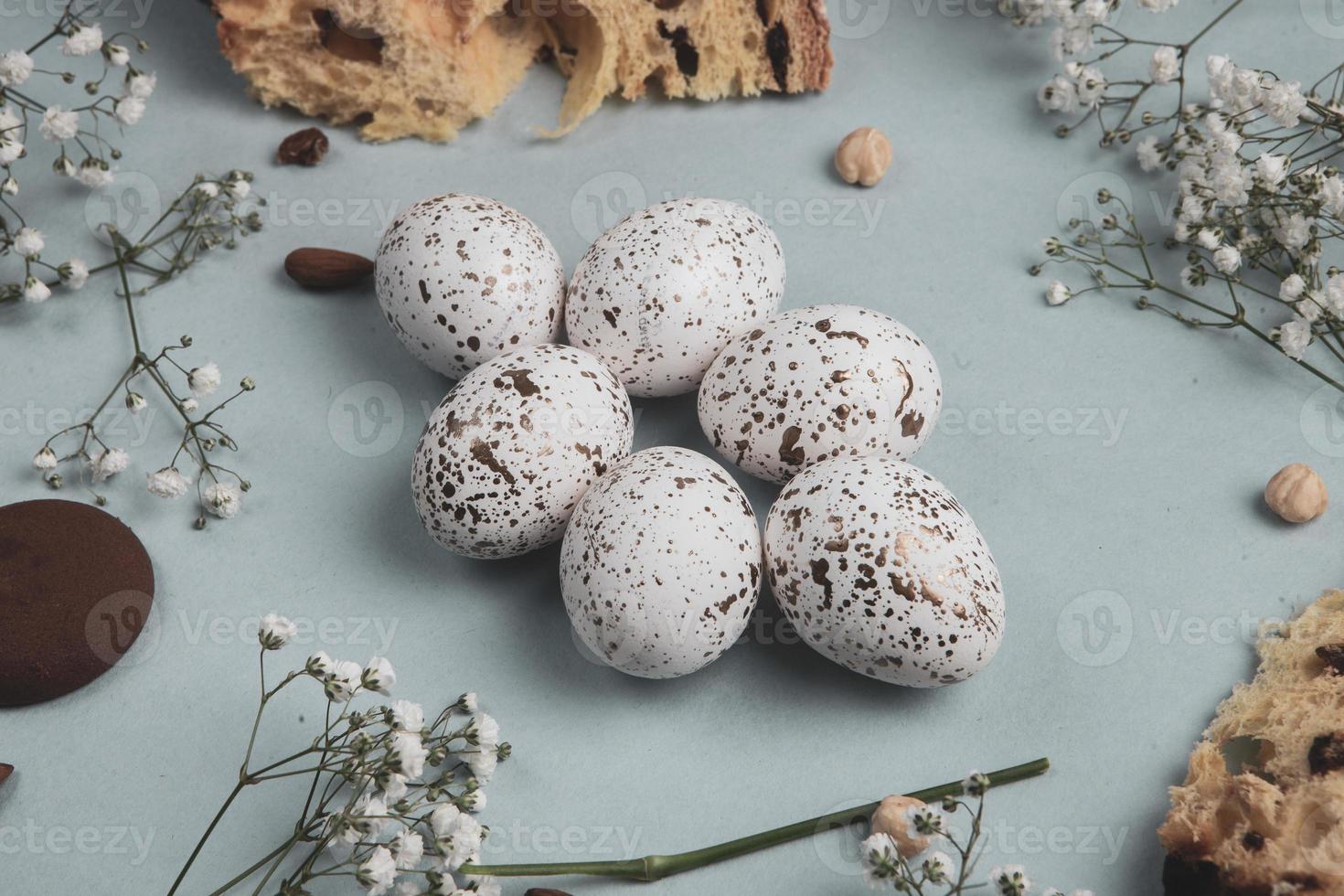 banner. Easter frame with eggs and feathers on a blue wooden background. Minimal concept. View from above. Card with copy space for text. photo