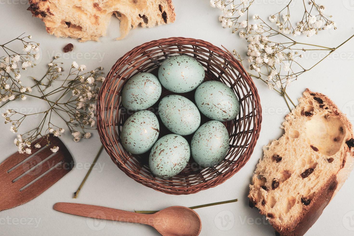 banner. Easter frame with eggs and feathers on a blue wooden background. Minimal concept. View from above. Card with copy space for text. photo