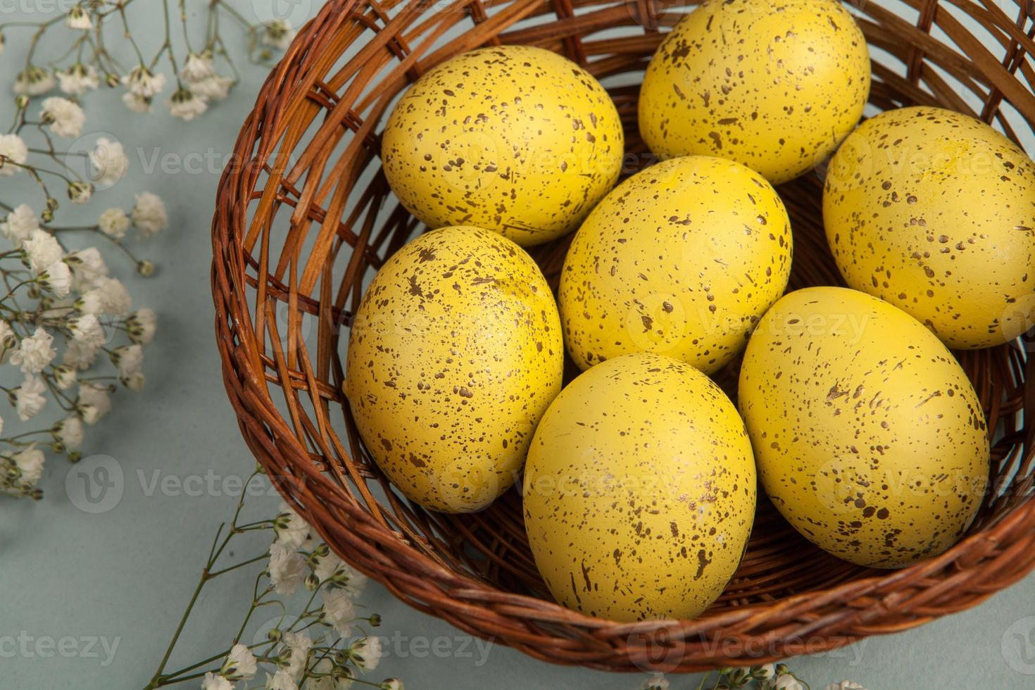 banner. Easter frame with eggs and feathers on a blue wooden background. Minimal concept. View from above. Card with copy space for text. photo