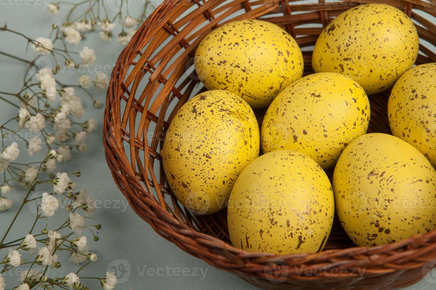 banner. Easter frame with eggs and feathers on a blue wooden background. Minimal concept. View from above. Card with copy space for text. photo