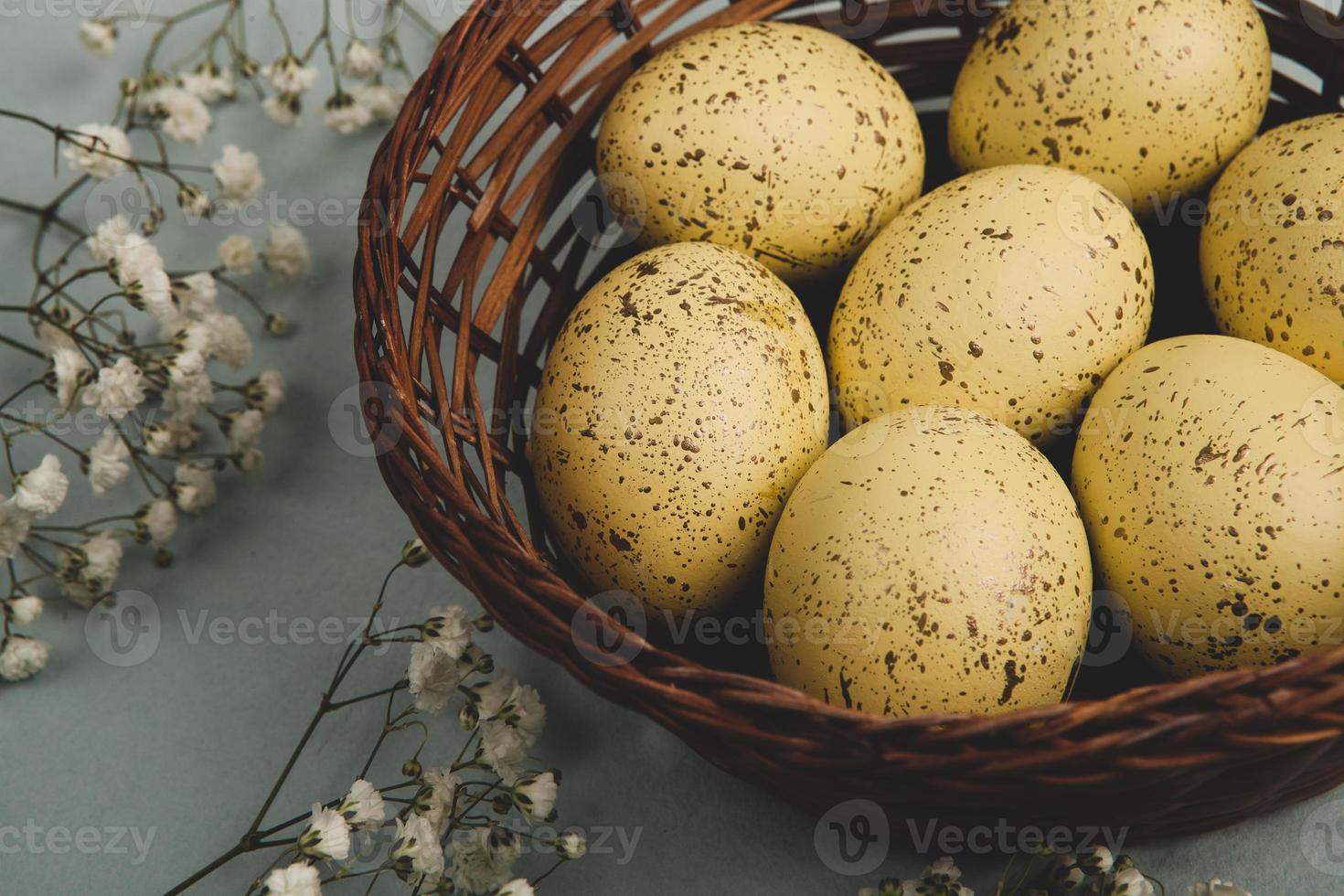 banner. Easter frame with eggs and feathers on a blue wooden background. Minimal concept. View from above. Card with copy space for text. photo