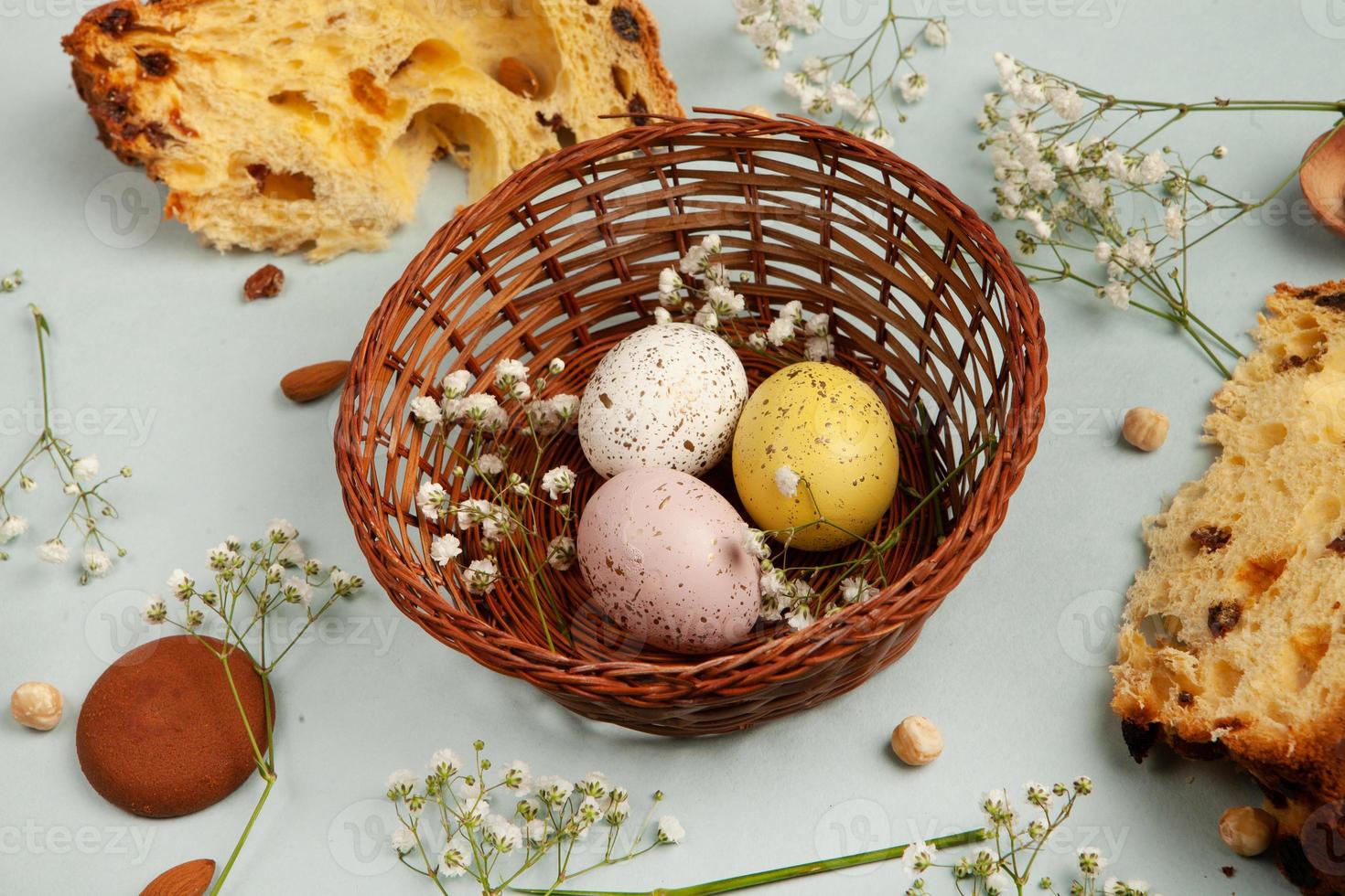 banner. Easter frame with eggs and feathers on a blue wooden background. Minimal concept. View from above. Card with copy space for text. photo